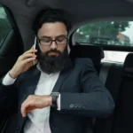 businessman-while-traveling-by-car-back-seat-using-smartphone