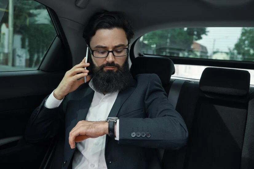 businessman-while-traveling-by-car-back-seat-using-smartphone